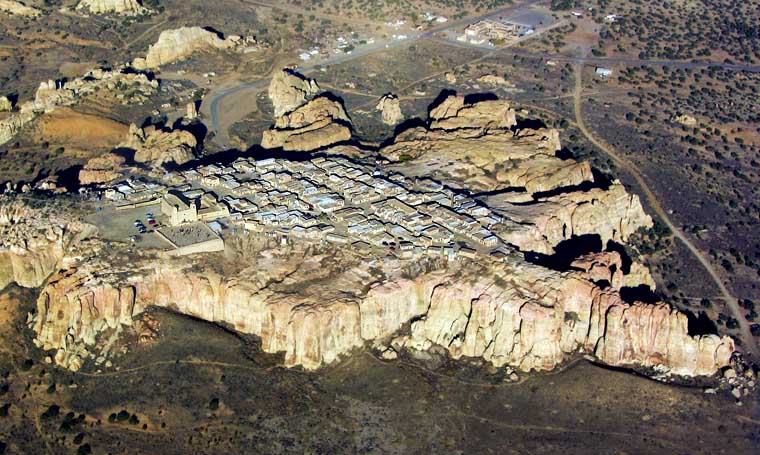 An aerial view looking down on the mesa top where the Pueblo of Acoma is perched