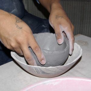 Placing the clay into the bowl form