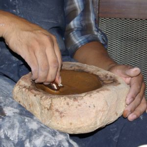 Adding processed bee-weed to the brown paint mix