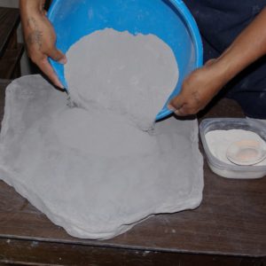 Pouring out the ground clay for mixing