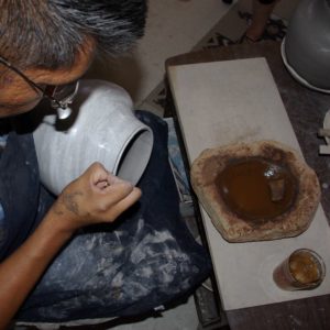 Brown paint being applied with a yucca brush