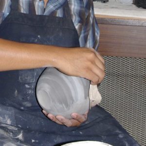 Using a cloth to apply the white slip