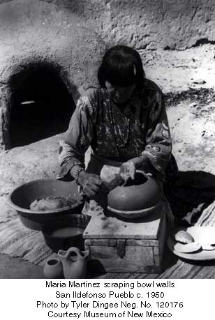 Maria scraping the outside walls of her pots