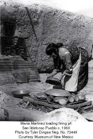 Maria stacking pottery in her firing pit before firing