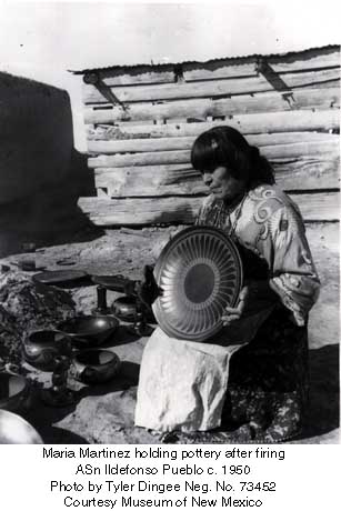 Maria displaying a plate that was just fired