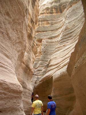 People in the bottom of a slot canyon at Kasha Katuwe Tent Rocks National Monument
