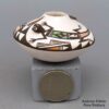 Carolyn Concho, lkac2l295: Miniature polychrome jar with applique and painted lizard, ladybug, and geometric design