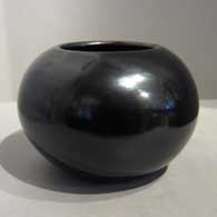 A plain, polished black fist-pot