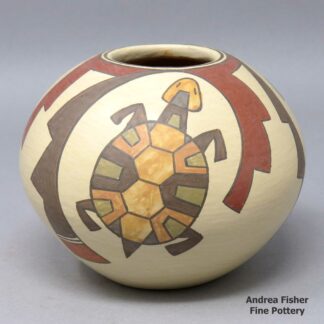 A polychrome jar with a 3-panel turtle and geometric design