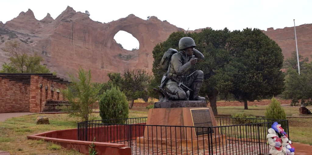Bronze monument to the Navajo code talkers of World War 2 in Window Rock, with Window Rock itself in the background